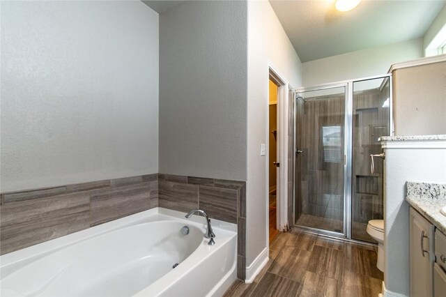 8022 Calgary Dr, Corpus Christi, TX 78414 - full bath featuring vanity, a stall shower, a bath, and wood finished floors