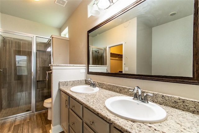 8022 Calgary Dr, Corpus Christi, TX 78414 - full bath featuring a shower stall, double vanity, a spacious closet, and wood finished floors