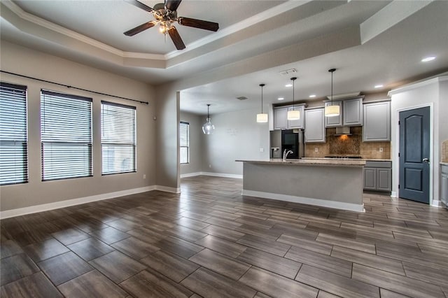 8022 Calgary Dr, Corpus Christi, TX 78414 - kitchen featuring a tray ceiling, crown molding, fridge with ice dispenser, recessed lighting, and backsplash