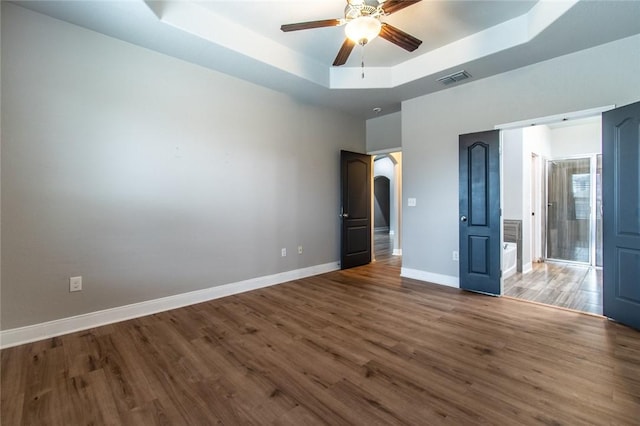 8022 Calgary Dr, Corpus Christi, TX 78414 - unfurnished bedroom featuring a tray ceiling and wood finished floors