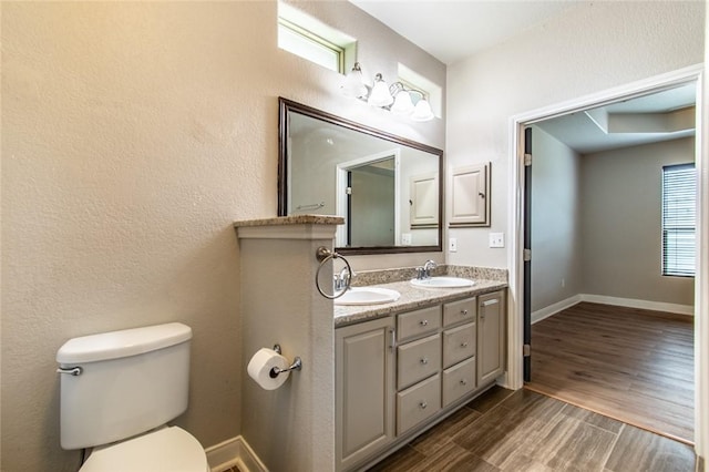 8022 Calgary Dr, Corpus Christi, TX 78414 - bathroom with double vanity, wood finished floors, and a textured wall