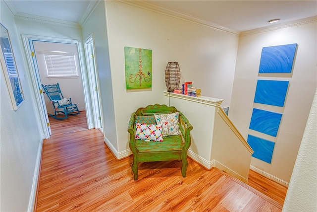 hall with light wood-type flooring and crown molding