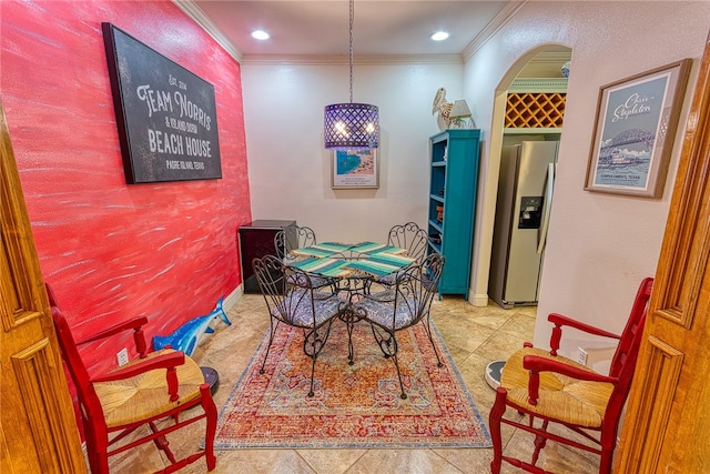 dining room with ornamental molding and light tile patterned floors