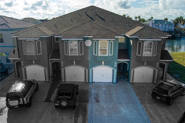 view of front of home featuring a garage and a water view