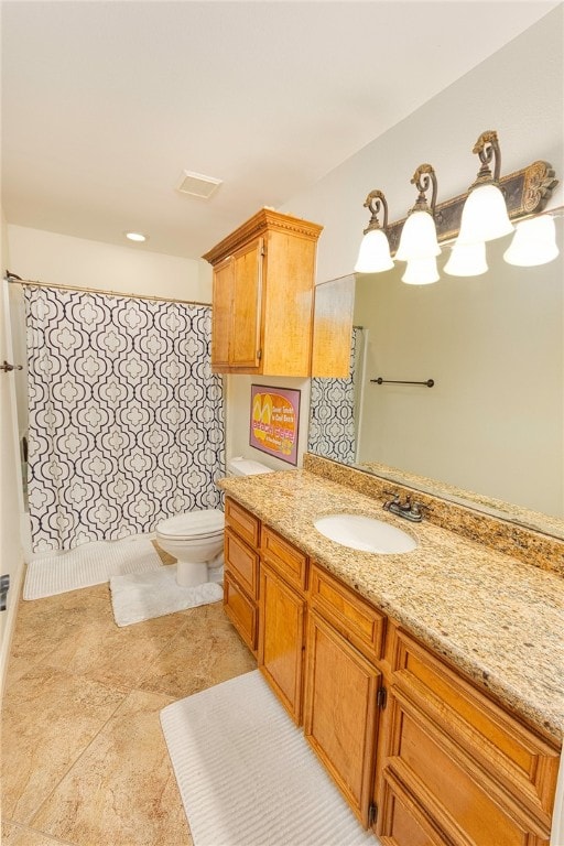 bathroom with vanity, tile patterned floors, and toilet