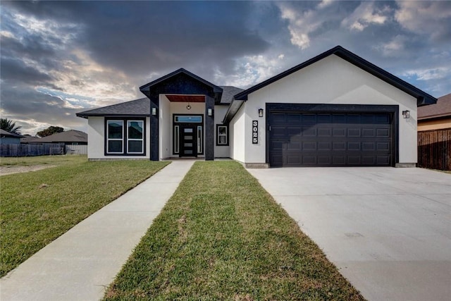 view of front of home featuring a front yard and a garage