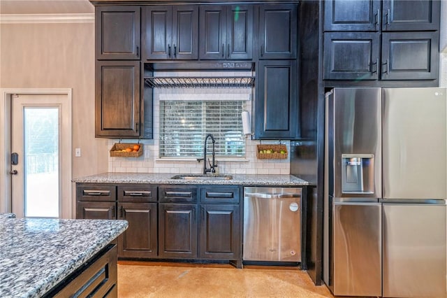 4609 Tuscan Way, Corpus Christi, TX 78410 - kitchen with appliances with stainless steel finishes, backsplash, crown molding, light stone countertops, and dark brown cabinetry