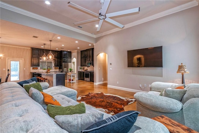 4609 Tuscan Way, Corpus Christi, TX 78410 - living room with arched walkways, a ceiling fan, recessed lighting, ornamental molding, and a chandelier