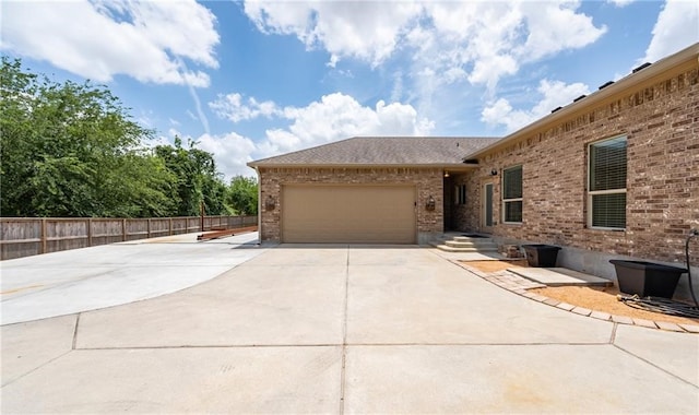4609 Tuscan Way, Corpus Christi, TX 78410 - view of side of home featuring brick siding, driveway, a garage, and a shingled roof