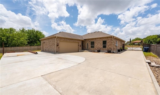 4609 Tuscan Way, Corpus Christi, TX 78410 - view of front facade with brick siding, a garage, and driveway