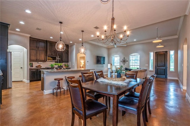 4609 Tuscan Way, Corpus Christi, TX 78410 - dining area with arched walkways, concrete floors, crown molding, a chandelier, and recessed lighting
