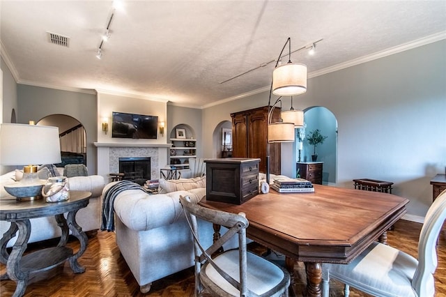 261 Louisiana Ave, Corpus Christi, TX 78404 - dining room featuring arched walkways, rail lighting, ornamental molding, and a fireplace