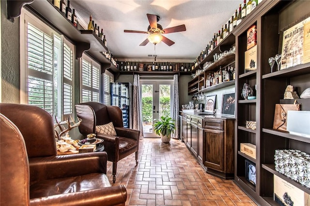 261 Louisiana Ave, Corpus Christi, TX 78404 - living area featuring brick flooring, a bar, a ceiling fan, and french doors