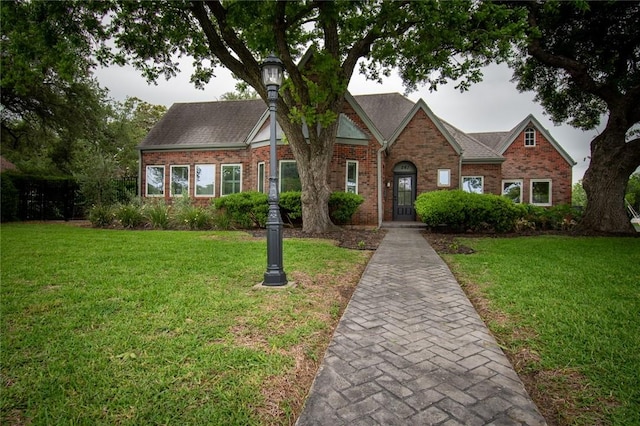 261 Louisiana Ave, Corpus Christi, TX 78404 - view of front of home featuring brick siding, a front lawn, and a shingled roof