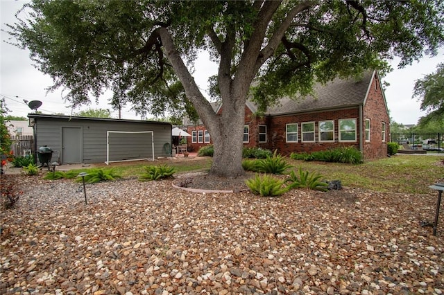 261 Louisiana Ave, Corpus Christi, TX 78404 - back of house featuring brick siding, fence, an outbuilding, and a shingled roof