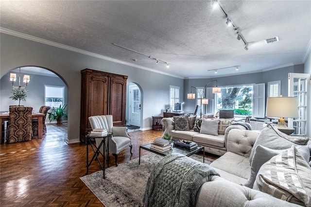 261 Louisiana Ave, Corpus Christi, TX 78404 - living area featuring arched walkways, rail lighting, baseboards, crown molding, and healthy amount of natural light