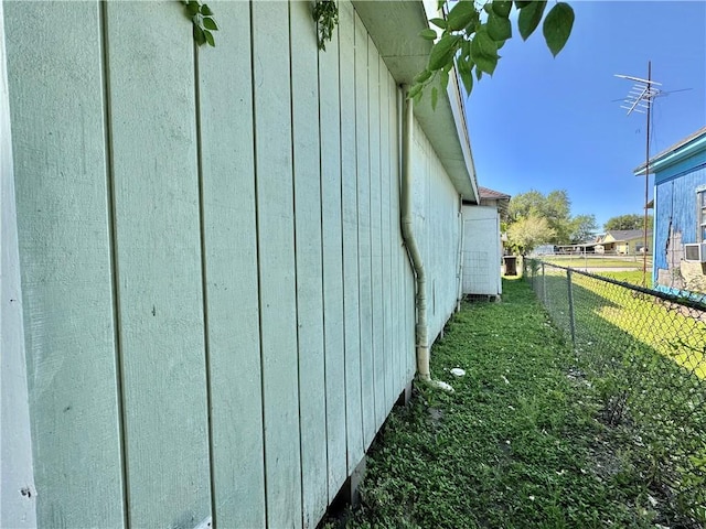 view of side of home with fence