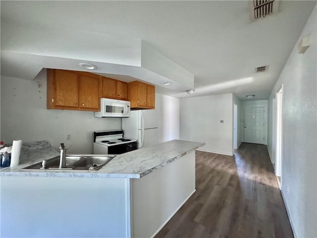 kitchen with white appliances, brown cabinetry, light countertops, a sink, and dark wood-style floors