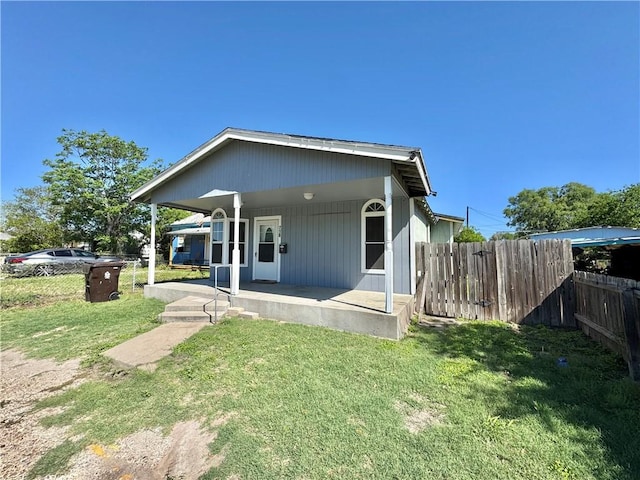 back of house with a yard and fence