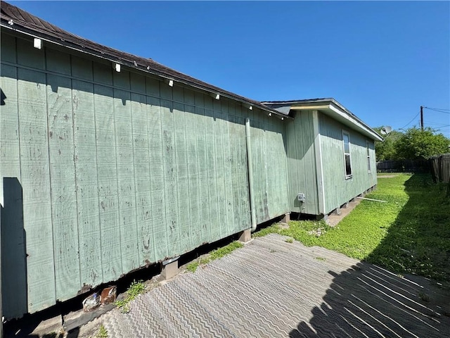 view of home's exterior featuring a yard and fence