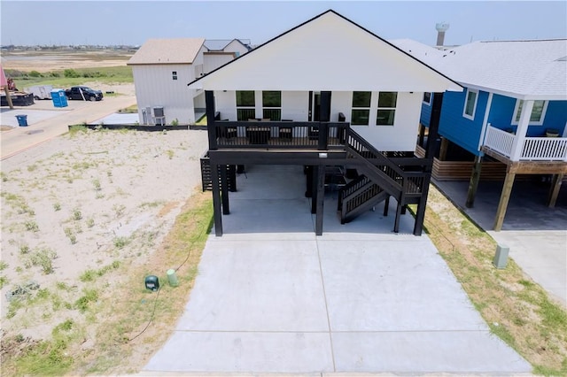 beach home featuring a carport, stairway, and driveway