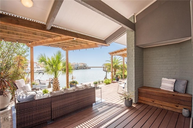 deck with outdoor lounge area, a pergola, and a water view