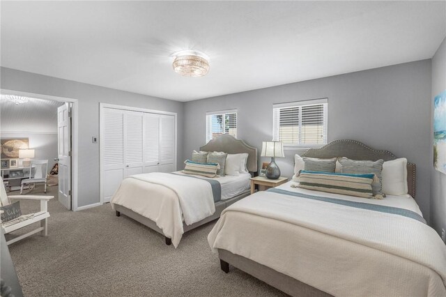 bedroom with baseboards, a closet, and carpet floors