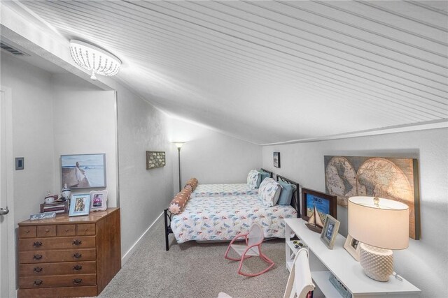 bedroom with carpet flooring, baseboards, visible vents, and vaulted ceiling