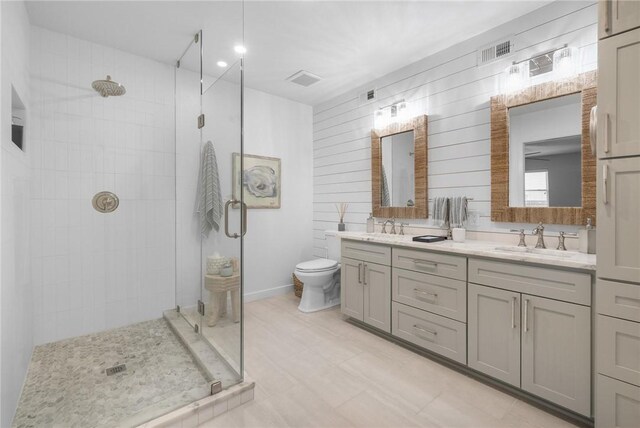 bathroom with visible vents, a stall shower, and a sink