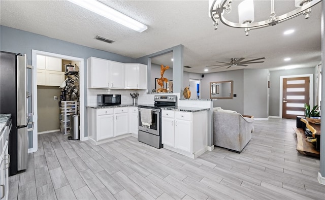 kitchen with white cabinetry, appliances with stainless steel finishes, and light stone counters