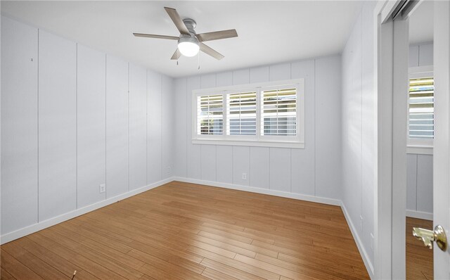 unfurnished room featuring light hardwood / wood-style floors and ceiling fan