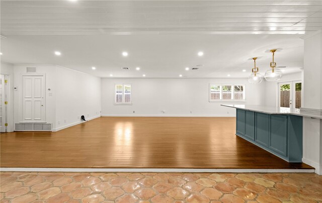 interior space with a healthy amount of sunlight, light hardwood / wood-style flooring, and ornamental molding