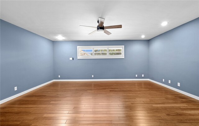 spare room featuring hardwood / wood-style flooring and ceiling fan