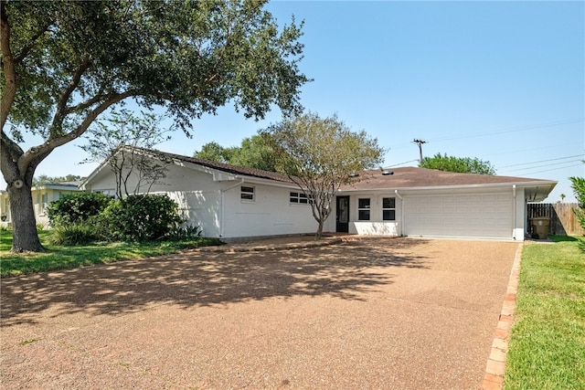 ranch-style home featuring a garage