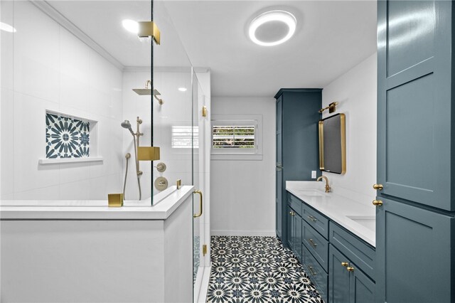 bathroom featuring a shower with shower door and vanity