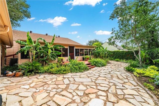 149 Rossiter St, Corpus Christi, TX 78411 - back of house with a sunroom, a patio area, and a shingled roof