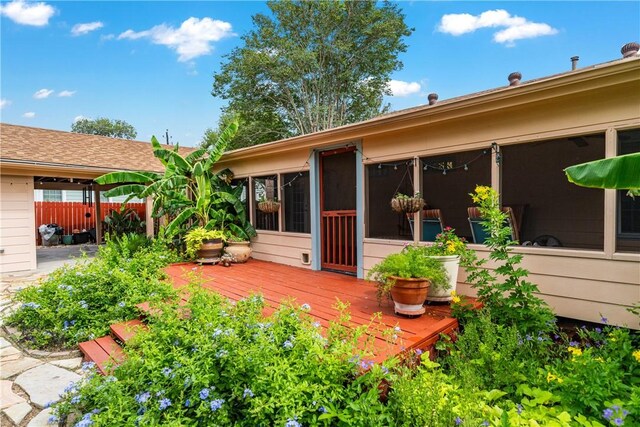 149 Rossiter St, Corpus Christi, TX 78411 - back of property featuring a wooden deck and a sunroom