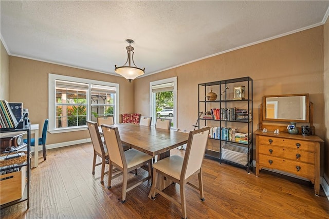 149 Rossiter St, Corpus Christi, TX 78411 - dining area with ornamental molding, hardwood / wood-style floors, a textured ceiling, and baseboards