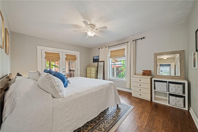 149 Rossiter St, Corpus Christi, TX 78411 - bedroom featuring french doors, multiple windows, dark wood-type flooring, and baseboards
