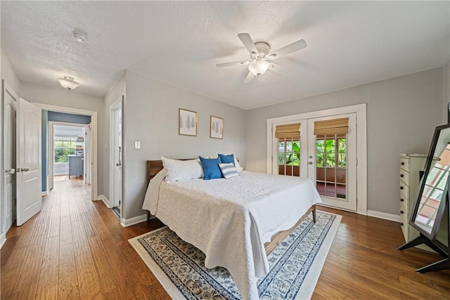 149 Rossiter St, Corpus Christi, TX 78411 - bedroom featuring access to exterior, french doors, wood finished floors, baseboards, and a textured ceiling