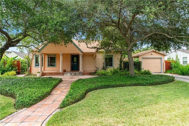149 Rossiter St, Corpus Christi, TX 78411 - view of front of house with concrete driveway, a detached garage, a porch, and an outdoor structure
