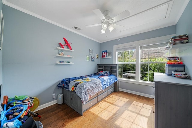 149 Rossiter St, Corpus Christi, TX 78411 - bedroom featuring attic access, crown molding, light wood-style flooring, baseboards, and a ceiling fan