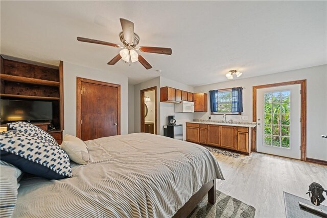 149 Rossiter St, Corpus Christi, TX 78411 - bedroom featuring a sink, light wood-type flooring, baseboards, and access to exterior