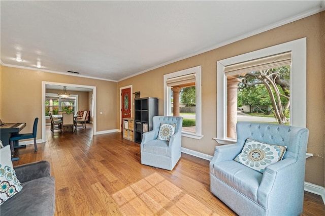 149 Rossiter St, Corpus Christi, TX 78411 - living area featuring plenty of natural light, light wood-style flooring, baseboards, and crown molding