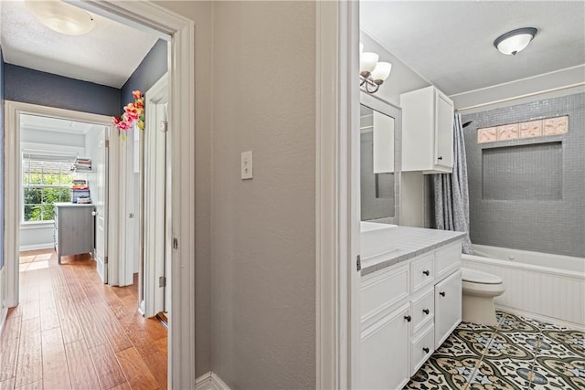 149 Rossiter St, Corpus Christi, TX 78411 - full bath featuring vanity, shower / bathtub combination with curtain, wood finished floors, toilet, and baseboards
