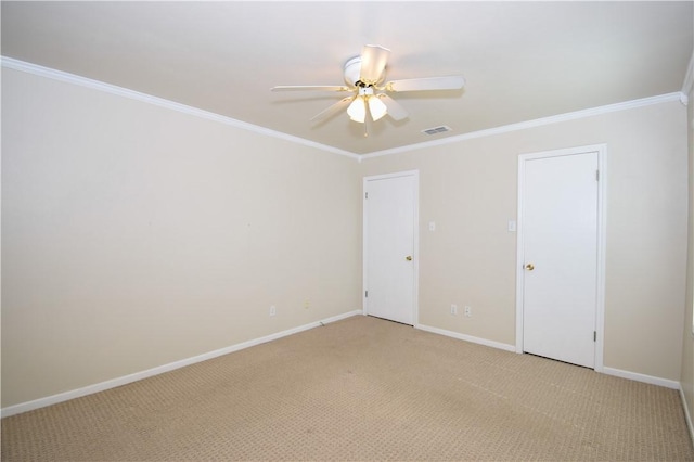 empty room featuring a ceiling fan, baseboards, visible vents, ornamental molding, and light carpet