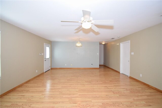 empty room with light wood-style flooring, baseboards, and ceiling fan