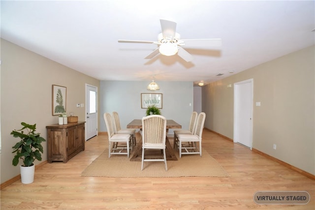 dining room featuring baseboards, light wood-style flooring, and a ceiling fan