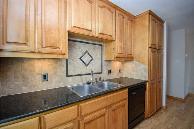 kitchen with light wood-style flooring, a sink, backsplash, baseboards, and dishwasher