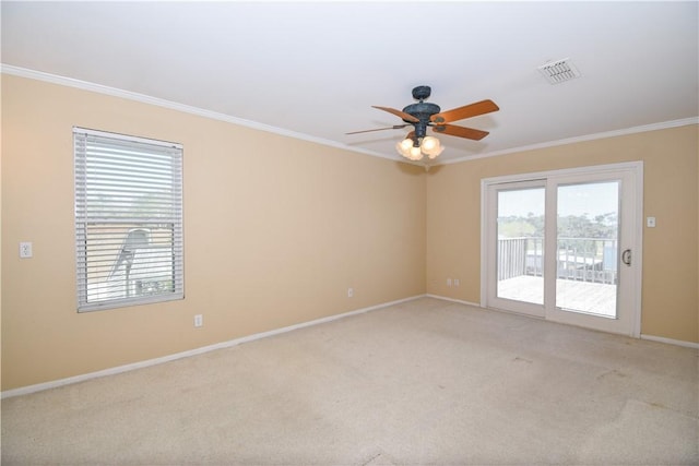 carpeted empty room featuring visible vents, baseboards, ceiling fan, and ornamental molding